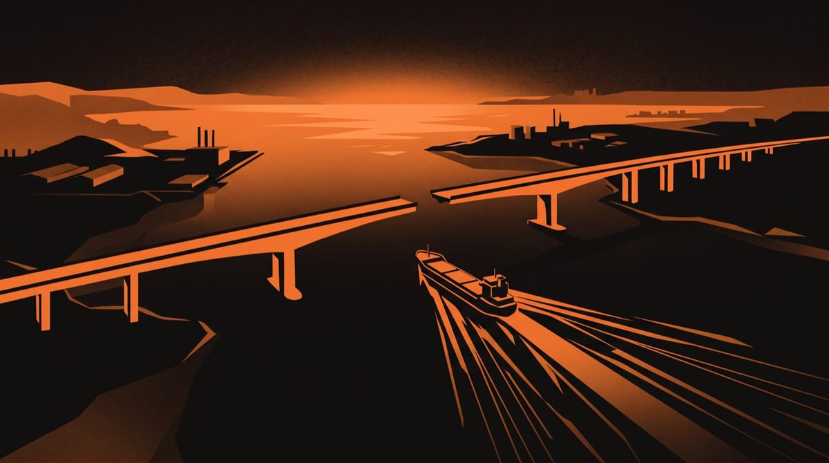 Two halves of a long bridge reaching toward each other from opposite shores across wide water at sunset, seen from the air, their spans almost meeting in the middle.